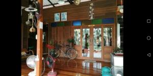 a house with a bike in the middle of a room at Baan Ing Suan in Amphawa