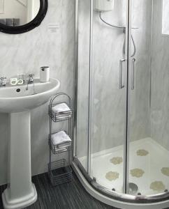 a bathroom with a shower and a sink at Alderberry Lodge in Newquay