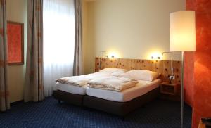 Postel nebo postele na pokoji v ubytování Ambiente Hotel Freieck