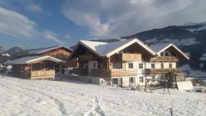 a ski lodge on a snowy hill with snow covered at Schorpenhof in Fügenberg