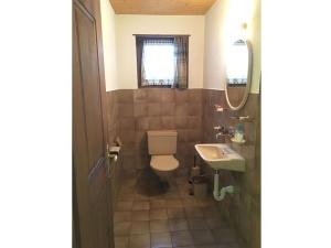 a bathroom with a toilet and a sink at Ferienhaus Somareiva in Savognin
