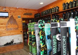 a bunch of snowboards are lined up in a room at PM Services Riverside Apartments in Madzhare