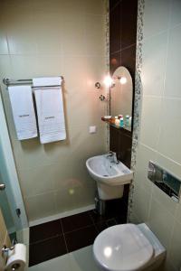 a small bathroom with a sink and a toilet at Rg Status Hotel in Paralia Katerinis