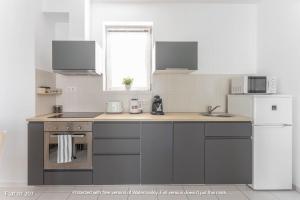 a kitchen with a stove and a refrigerator at Corvin Plaza Apartments & Suites in Budapest