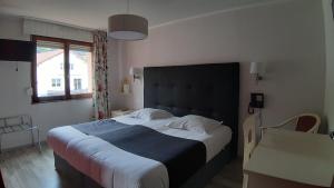 Postel nebo postele na pokoji v ubytování Hotel De La Route Verte