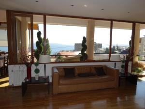 a living room with a couch and large windows at View Hotel BRC in San Carlos de Bariloche