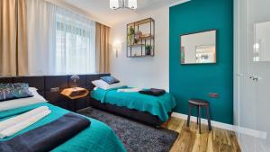 Posteľ alebo postele v izbe v ubytovaní Apartamenty Piano by Royal Aparts