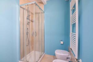 a bathroom with a shower and a toilet at Al Giardino Del Nespolo in Polignano a Mare