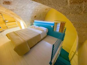 a bedroom with a bed in a large room at Al Giardino Del Nespolo in Polignano a Mare