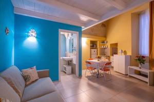 a living room with a table and a blue wall at Al Giardino Del Nespolo in Polignano a Mare