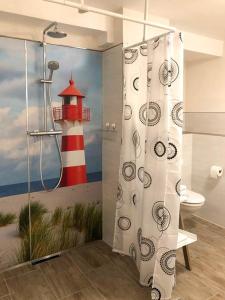 a bathroom with a shower curtain with a lighthouse at Ferienwohnung im Zentrum Brilons in Brilon