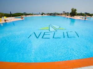 a large swimming pool with the words la valle at Villetta La Ginestra in Stintino