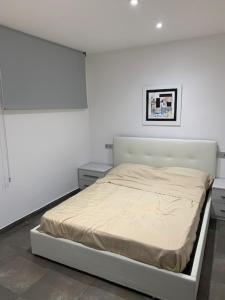 um quarto branco com uma cama num quarto em Calafell Torre Sol 4 em Calafell