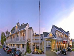 a large building with cars parked in a parking lot at Parkside Inn Bridgeview in Mackinaw City