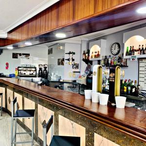 a bar with a wooden counter top in a restaurant at Hostal Gabino in Isla