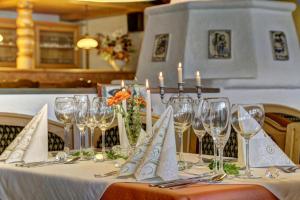 a table with wine glasses and candles on it at Ferienhotel Kollmerhof in Rimbach +6 photos