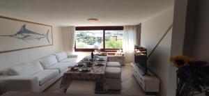 ein Wohnzimmer mit einem weißen Sofa und einem Tisch in der Unterkunft Porto Rotondo in Porto Rotondo