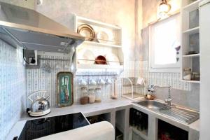 a kitchen with a sink and a counter top at Paros Stylish central loft in Parikia