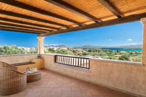 a balcony with a view of the ocean at Homey Experience - Terrace Sea View Apartment in Olbia +9 photos