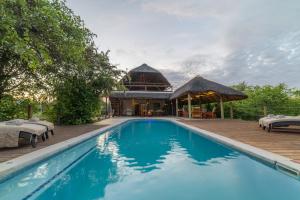 a pool with a pavilion and a house at Lengau Lodge in Grietjie Nature Reserve