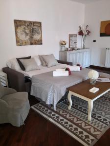 a living room with a bed and a coffee table at Perugino Apartments in Fiumicino