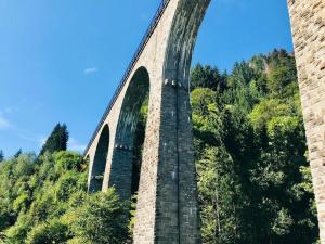 a large bridge with two arches on a hill at Hotel Zartenbach B&B in Hinterzarten
