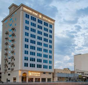 Un edificio alto con un cartel encima. en Season Star Hotel Madinah, en Medina