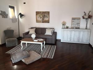a living room with a couch and a coffee table at Perugino Apartments in Fiumicino