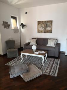 a living room with a couch and a coffee table at Perugino Apartments in Fiumicino