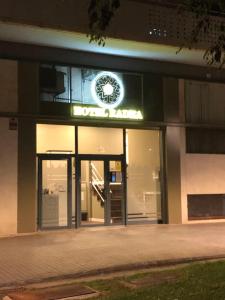a building with a clock on the front of it at Hotel Radha in Hospitalet de Llobregat