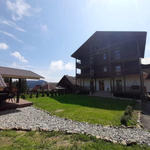 a large house with a grassy yard in front of it at Бо&Не in Yablunytsya