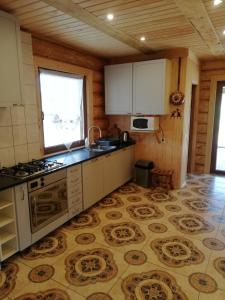 a kitchen with a sink and a stove top oven at RUNČI in Lautere