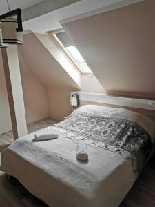 a bedroom with a bed in a attic at Szabó Lux Apartman in Sárvár