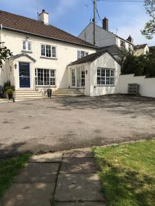 a large white house with a large driveway at Lynwood House Self Contained Studio in Tregoney