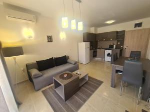 a living room with a couch and a table at Private Apartment in Star Dreams Complex in Sveti Vlas