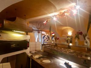 a kitchen with a counter and a stove top oven at Kirchenwirt Kolbnitz in Unterkolbnitz