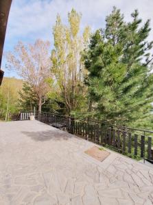 a walkway with a fence and trees at Residence Serra La Nave in Ragalna