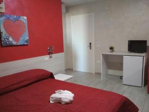 a red bedroom with a bed with a red wall at B&B Casa Dany in Ricadi