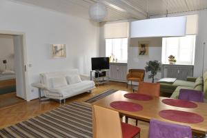 a living room with a table and a couch at Apartments Alter Platz in Klagenfurt