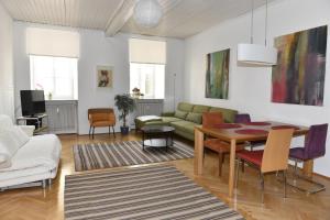 a living room with a couch and a table at Apartments Alter Platz in Klagenfurt