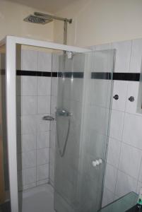 a shower with a glass door in a bathroom at Haus Brenntara 1 in Rangersdorf +14 photos