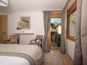 Postel nebo postele na pokoji v ubytování Chez Nous Zermatt