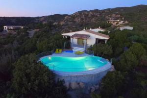an overhead view of a house with a swimming pool at Villa Con Piscina Vista Mare in Cala Bitta