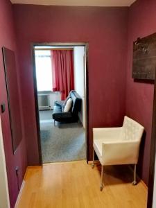 a living room with a mirror and a chair at Apartment Angelika in Zell am See