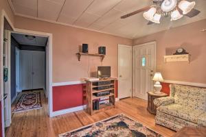 a living room with a couch and a tv at Pet-Friendly Columbus Cottage with Deck, Near Lakes! in Columbus