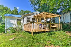 a house with a deck with chairs on it at Pet-Friendly Columbus Cottage with Deck, Near Lakes! in Columbus