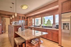 a kitchen with a large island in the middle at Pet-Friendly CO Springs Home with Koi Pond and Patio in Colorado Springs