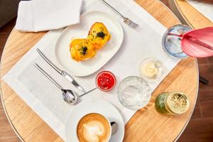 a table with a plate of food and a cup of coffee at Sir Anthony in Playa de las Americas