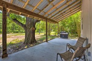 a covered porch with two chairs and a grill at Secluded Home with Gas Grill, 3 Mi to Boating! in Yantis