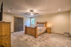 a bedroom with a bed and a ceiling fan at Secluded Home with Gas Grill, 3 Mi to Boating! in Yantis